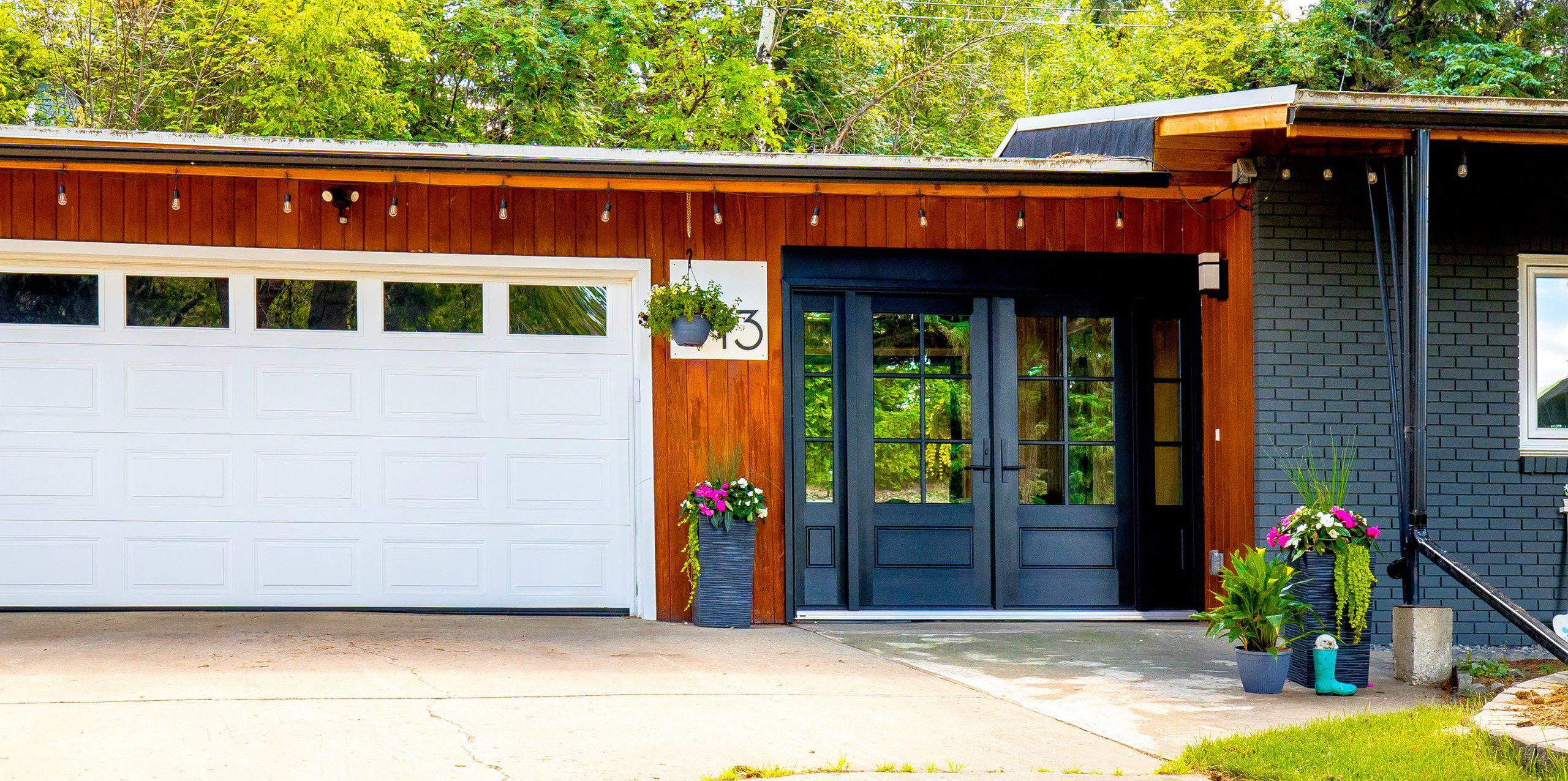 black doors on a wood sided house